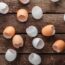 Empty egg shells on wooden background, top view.