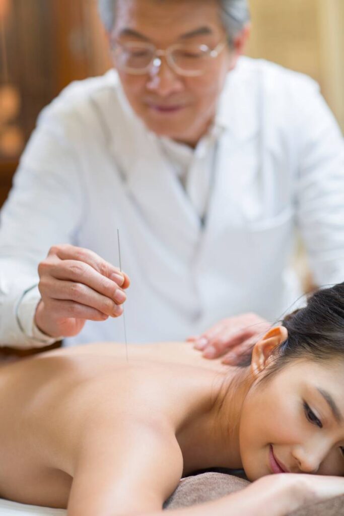 Young Chinese woman receiving acupuncture
