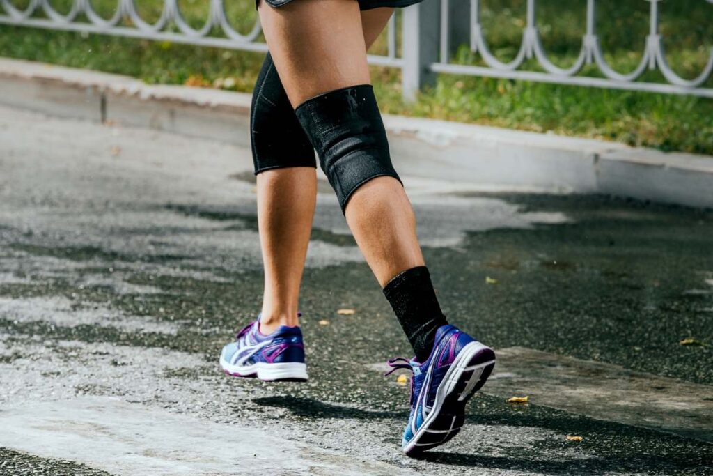 legs women athletes in knee pad running sports race around city