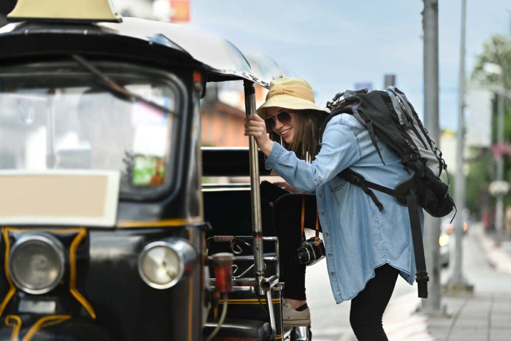 Happy caucasian female traveler with backpack on holiday vacation trip in Thailand. Blogger, vacation and journey concept.