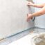 craftsman tiling the room with large format tiling. High quality photo