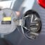 Close up of fuel tank door of the car; car refueling at a petrol station; car tank refilling at a gas station