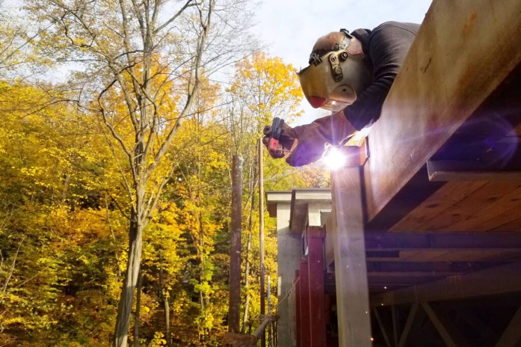 Welding work, welder welding metal material in heavy industry manufacturing